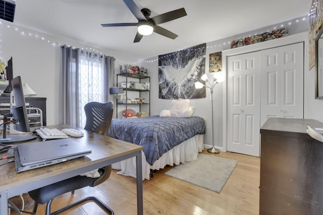 bedroom with light hardwood / wood-style floors, a closet, and ceiling fan