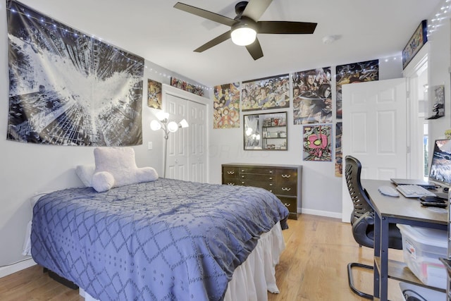 bedroom with hardwood / wood-style floors, ceiling fan, and a closet