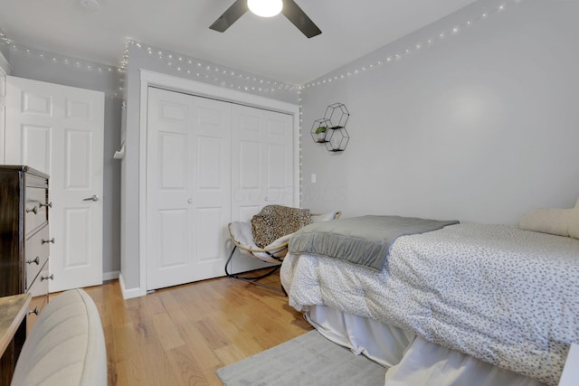 bedroom featuring ceiling fan, a closet, and light hardwood / wood-style flooring