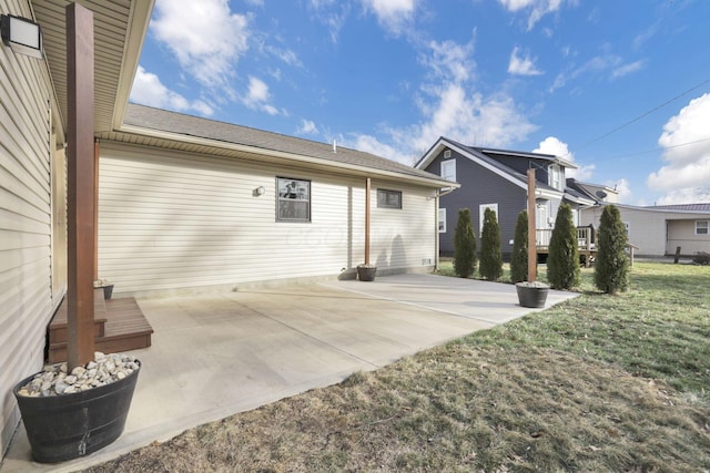 rear view of property with a patio and a lawn