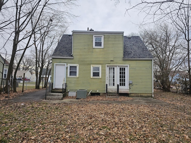 rear view of property featuring cooling unit