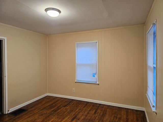 empty room featuring dark wood-type flooring