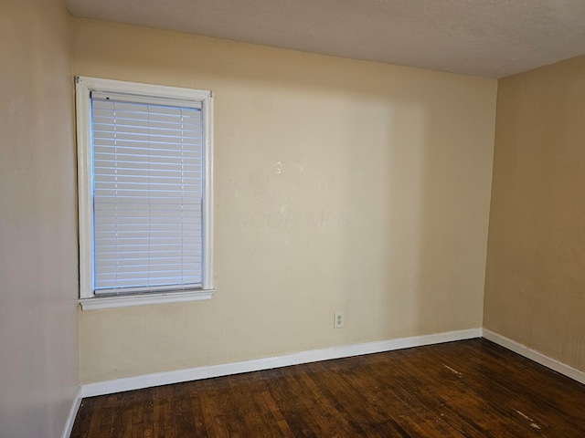 empty room with dark wood-type flooring