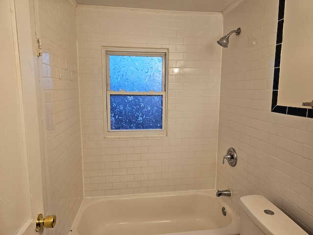 bathroom with tiled shower / bath, ornamental molding, and toilet