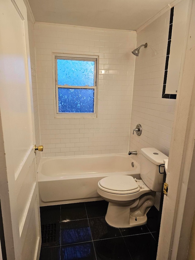 bathroom with tiled shower / bath, tile patterned floors, and toilet