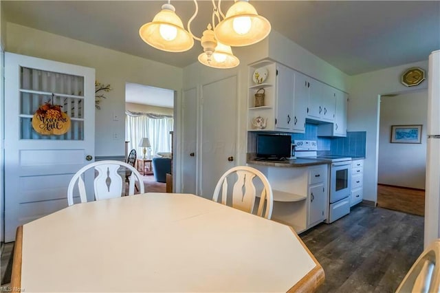 kitchen featuring white electric range, a chandelier, hanging light fixtures, dark hardwood / wood-style flooring, and white cabinets