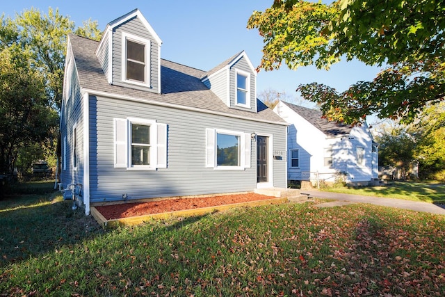 cape cod-style house with a front yard