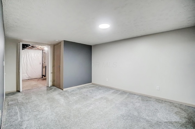 unfurnished room with light carpet