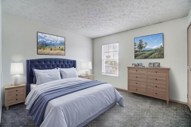 bedroom with dark carpet and a textured ceiling