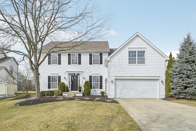 colonial-style house featuring a garage, driveway, and a front lawn