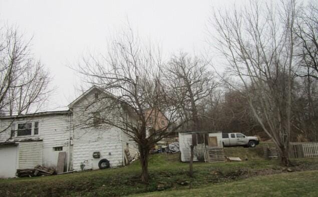 view of property exterior with a yard