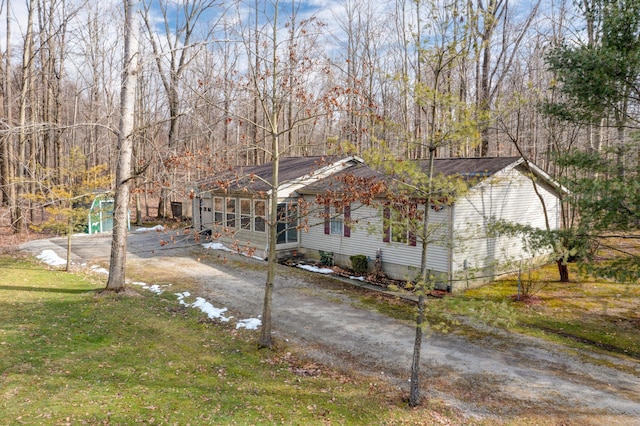 view of front of house with a front lawn and a sunroom
