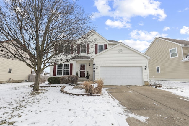 traditional-style house featuring an attached garage and driveway