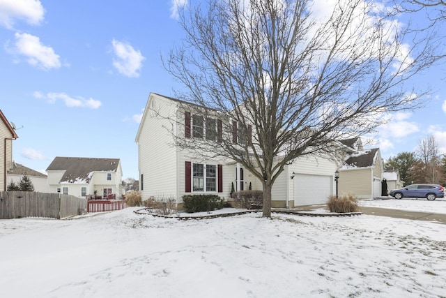 view of front of home featuring a garage and fence