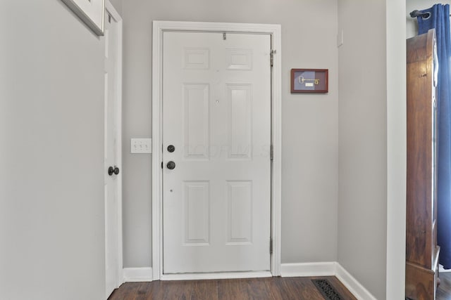 entryway featuring dark wood-type flooring and baseboards