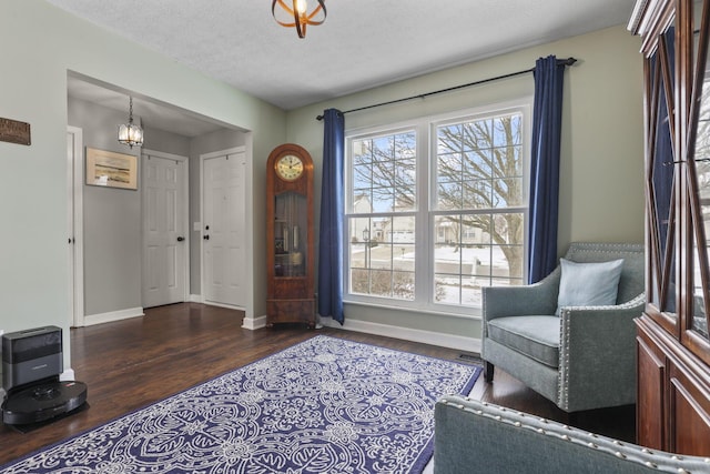 foyer featuring plenty of natural light, dark wood finished floors, a textured ceiling, and baseboards