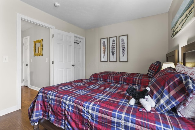 bedroom featuring dark wood-type flooring and baseboards