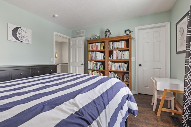 bedroom featuring dark wood finished floors and visible vents