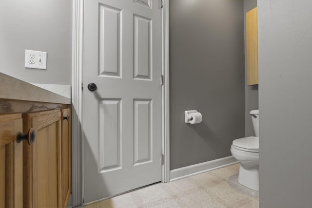 bathroom featuring toilet and baseboards