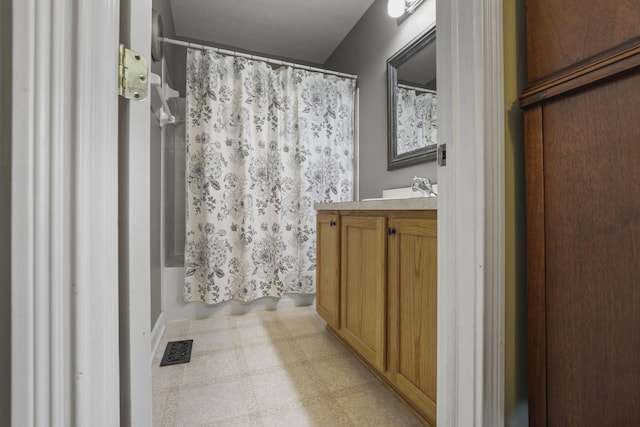 full bathroom featuring shower / bathtub combination with curtain, vanity, visible vents, and tile patterned floors