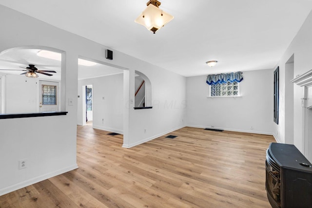 unfurnished living room featuring light hardwood / wood-style flooring and ceiling fan