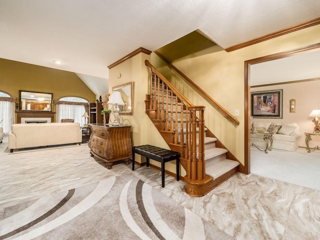 interior space featuring lofted ceiling, carpet, and crown molding