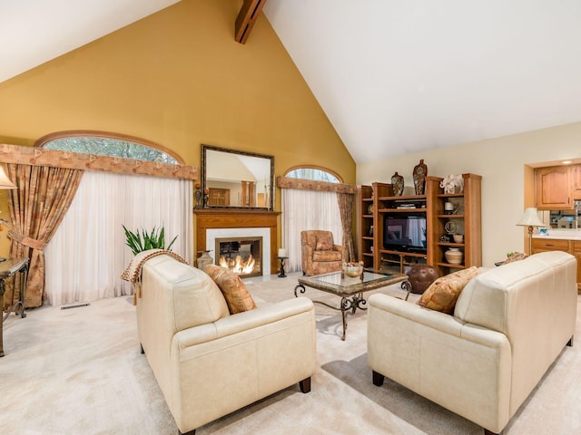 living area with visible vents, a glass covered fireplace, light carpet, high vaulted ceiling, and beamed ceiling