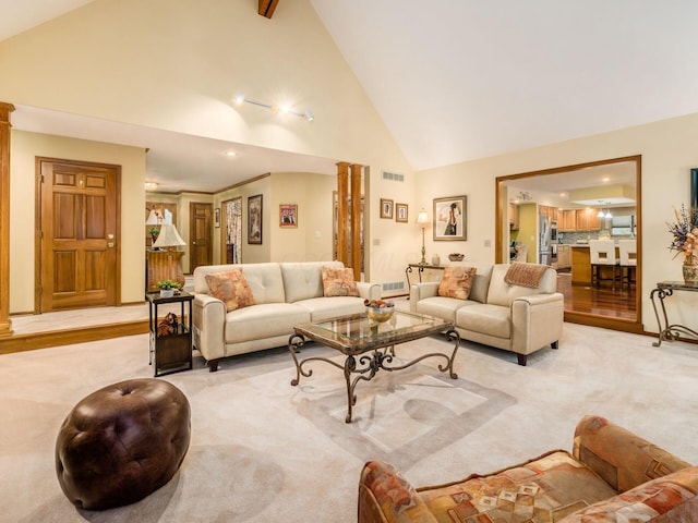 living area with high vaulted ceiling, light carpet, decorative columns, and visible vents