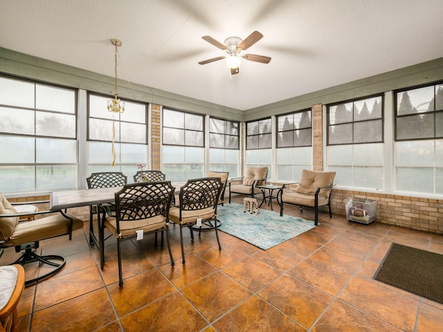 sunroom featuring a ceiling fan