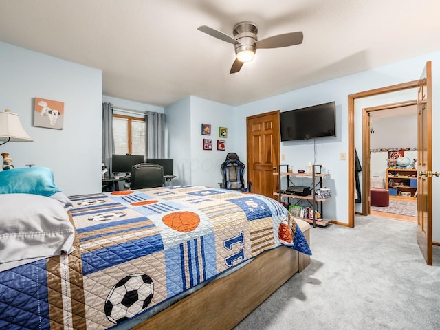 carpeted bedroom featuring ceiling fan and baseboards