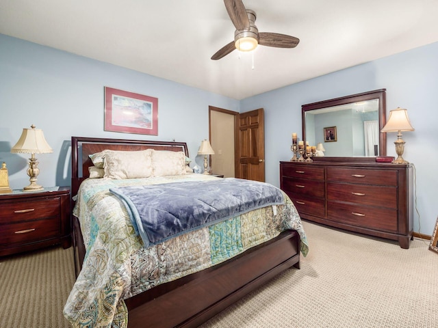 bedroom featuring light carpet, ceiling fan, and baseboards