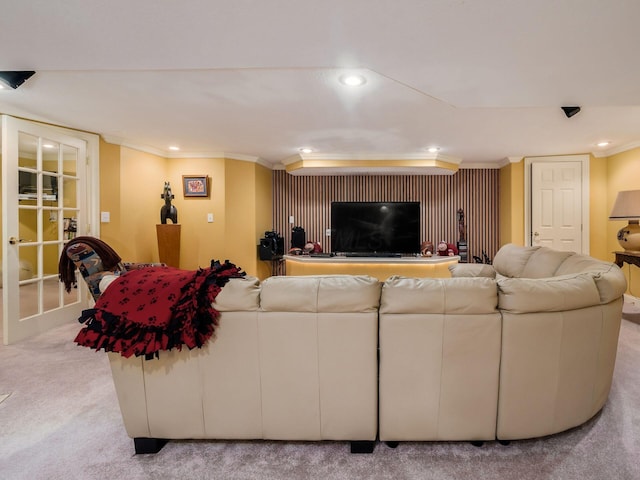 living area with recessed lighting, french doors, light colored carpet, and crown molding