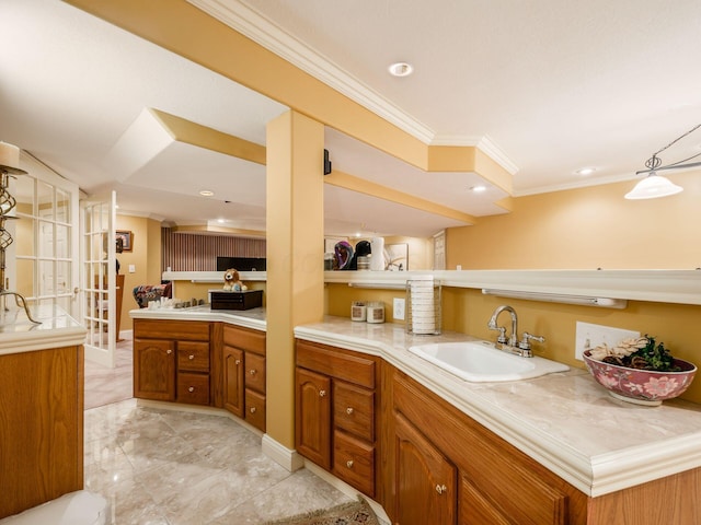 kitchen with recessed lighting, a sink, light countertops, ornamental molding, and brown cabinets