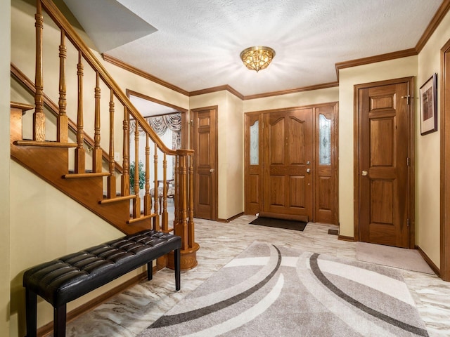 foyer entrance with a textured ceiling, ornamental molding, stairs, and baseboards