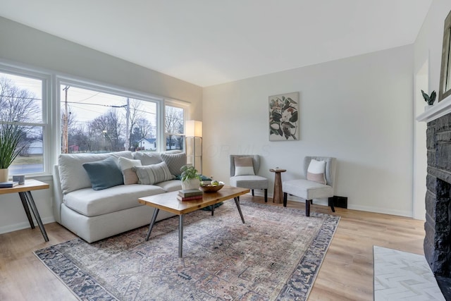 living room featuring light hardwood / wood-style flooring and a fireplace