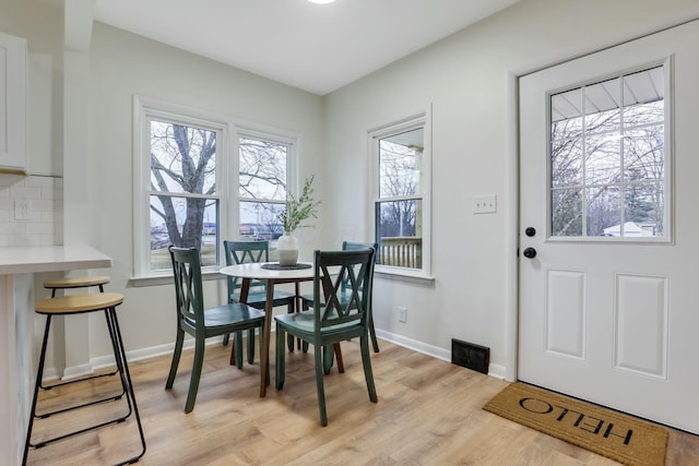 dining area with light hardwood / wood-style floors