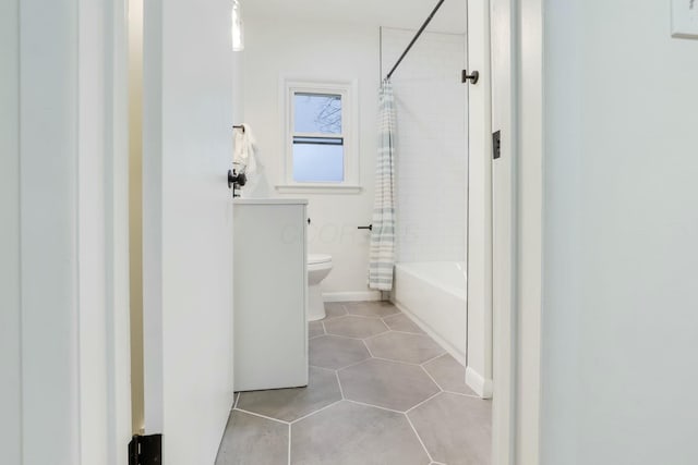 bathroom featuring shower / bath combo, tile patterned floors, and toilet