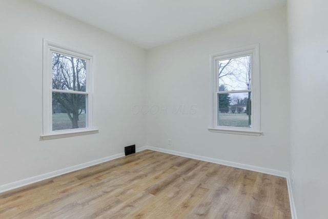 spare room featuring light wood-type flooring