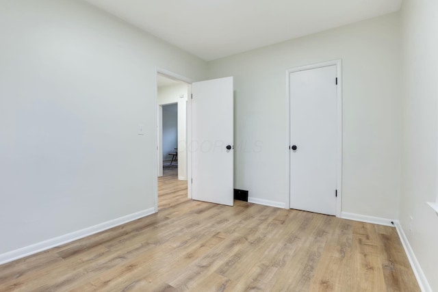 unfurnished bedroom with light wood-type flooring