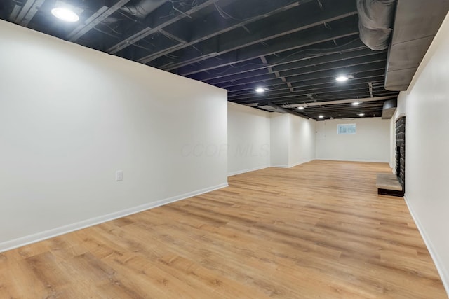 basement featuring hardwood / wood-style flooring