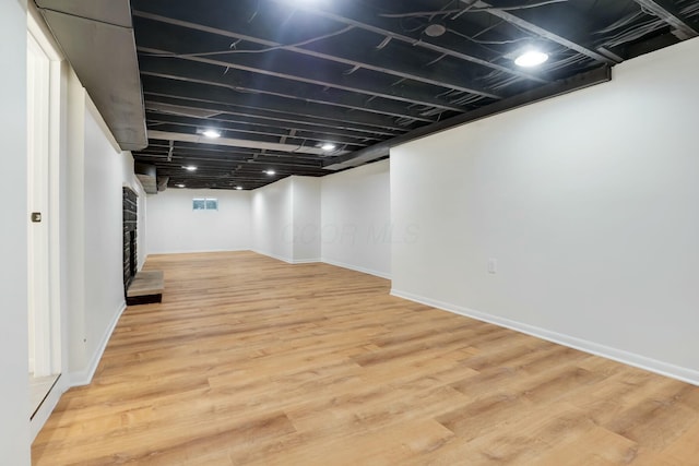 basement featuring light hardwood / wood-style floors