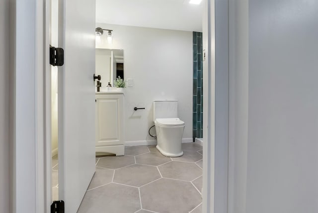 bathroom featuring tile patterned floors, toilet, and vanity