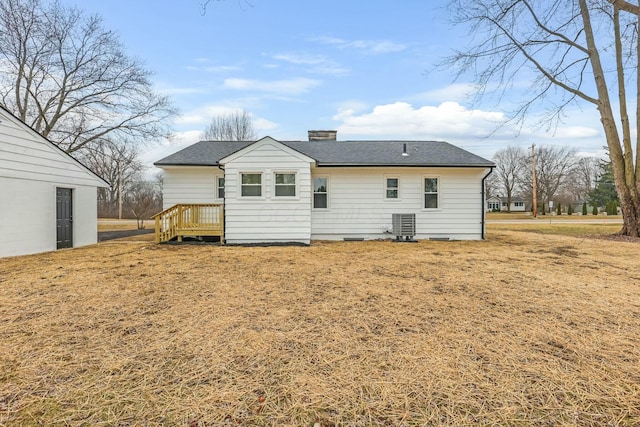 back of property featuring cooling unit and a lawn