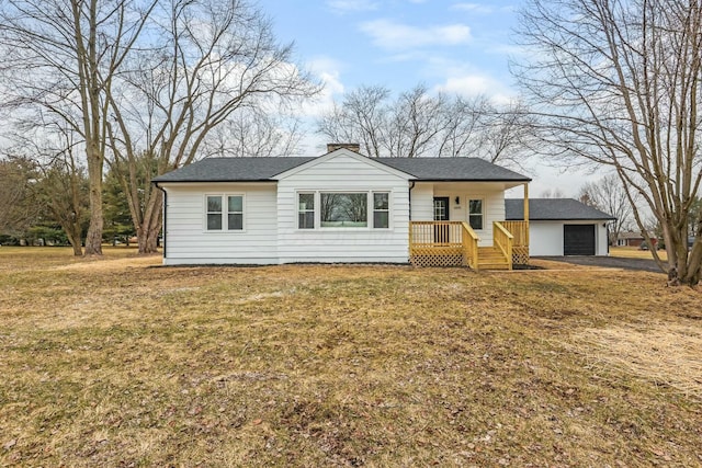 single story home featuring a porch, a garage, and a front lawn