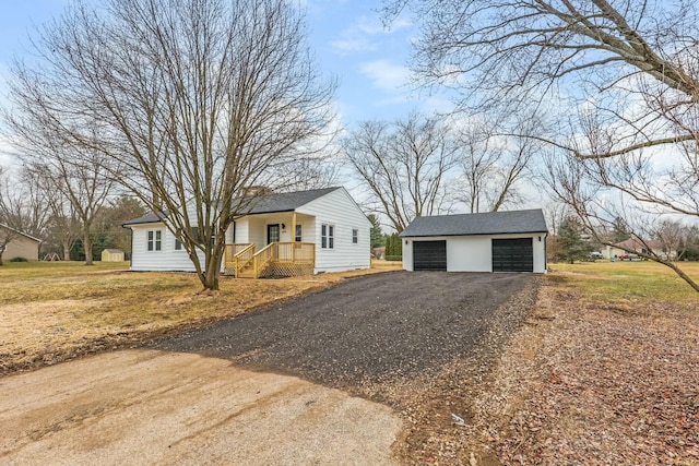 single story home with an outbuilding and a garage