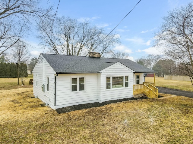 back of property featuring a lawn