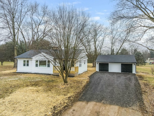 view of front of house with a garage, an outdoor structure, and a deck