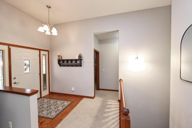 entryway with light wood-type flooring and a chandelier