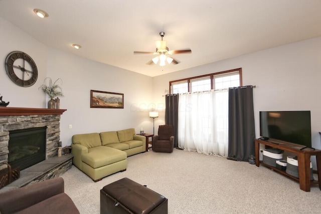 living room with ceiling fan, a fireplace, and carpet