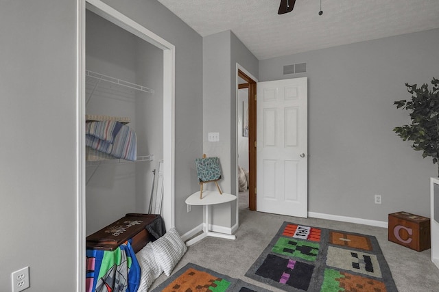 bathroom featuring ceiling fan and a textured ceiling